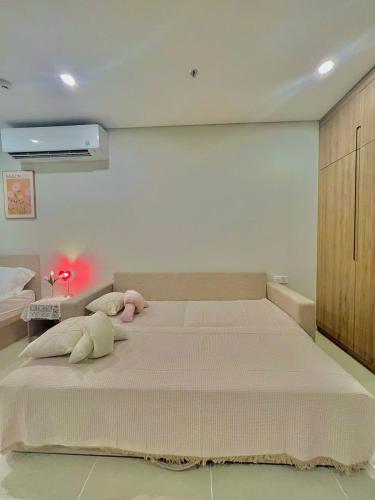 a bedroom with a large bed with a pink stuffed animal on it at Cloud Nine The Song Vung Tau Homestay in Vung Tau