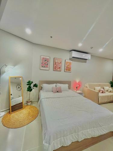 a bedroom with a large bed and a mirror at Cloud Nine The Song Vung Tau Homestay in Vung Tau