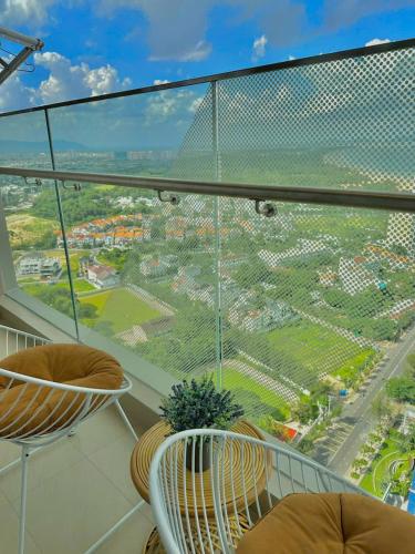 a balcony with chairs and a view of a city at Cloud Nine The Song Vung Tau Homestay in Vung Tau