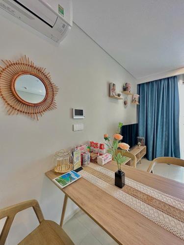 a dining room with a table and a mirror at Cloud Nine The Song Vung Tau Homestay in Vung Tau