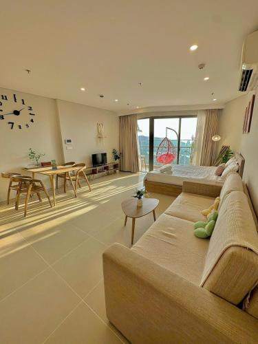 a large living room with a couch and a table at Cloud Nine The Song Vung Tau Homestay in Vung Tau