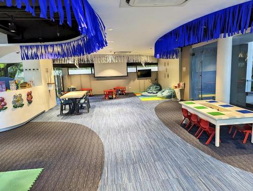 a conference room with tables and chairs and blue ceilings at Dominiks Comfort and silent Studio Tambuli Balcony Pool Mactan Ocean View High Floor in Lapu Lapu City