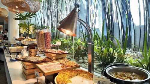 a buffet with many different types of food on display at Dominiks Comfort and silent Studio Tambuli Balcony Pool Mactan Ocean View High Floor in Lapu Lapu City
