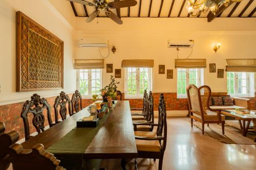 a large room with a long table and chairs at ELIVAAS Maison 10 - Luxe 4 BHK Villa With Pvt Pool, Garden & Portuguese Charm in Siolim