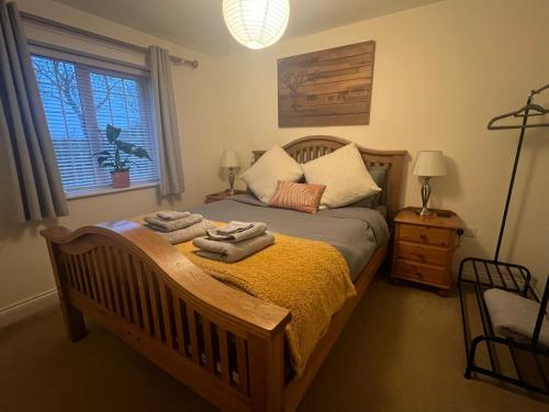 a bedroom with a bed with towels on it at Ashbourne Cottage in Ringwood