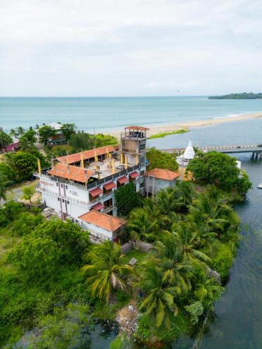 an aerial view of a building on a island in the water at Rise & Set Arugam bay in Arugam Bay