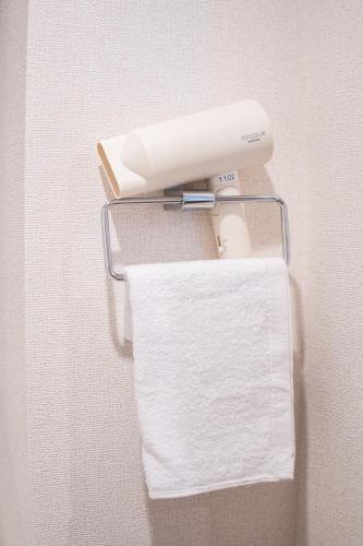 a roll of white paper towels on a towel rack at KINSHICHO Tokyo Holiday Hotel in Tokyo
