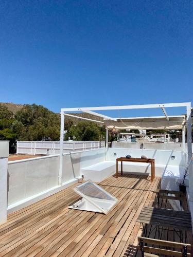 a deck of a boat with a table on it at Duplex con terraza en Agua Amarga in Agua Amarga