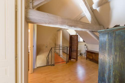 a hallway with wooden beams and a staircase in a house at La Maison de Maître, la plus grande des 3 maisons du Clos d'Isand'Or in Meursault