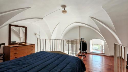 a bedroom with a bed and a dresser and a mirror at Casa Carmela a Presicce in Presicce