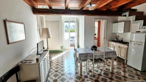 a kitchen with a table and a dining room at Casa Carmela a Presicce in Presicce