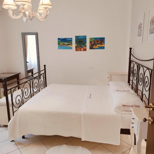 a bedroom with two beds and a mirror at Maison du VALe in Sesta Godano