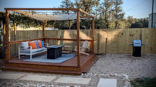 a wooden gazebo with a bench and a table at A Stunning Escape in Canyon Lake