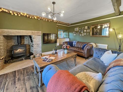 a living room with a couch and a fireplace at Hare and Hounds Exton in Exton