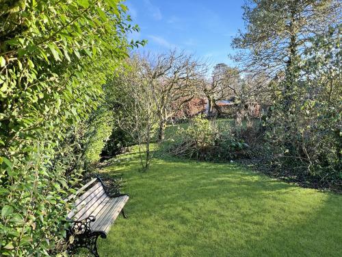 a park bench sitting in the middle of a yard at Hare and Hounds Exton in Exton