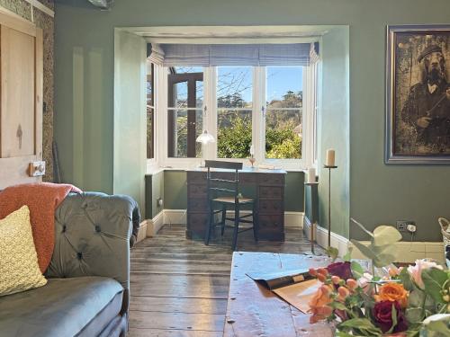 a living room with a desk and a window at Hare and Hounds Exton in Exton