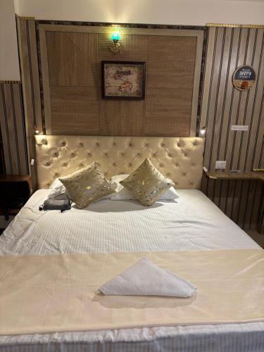 a bedroom with a large bed with a large headboard at Hills Royal Residency in Jālāpahār