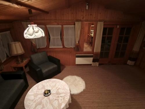 a living room with a couch and a table at Bergner's Blockhütte in Twielenfleth