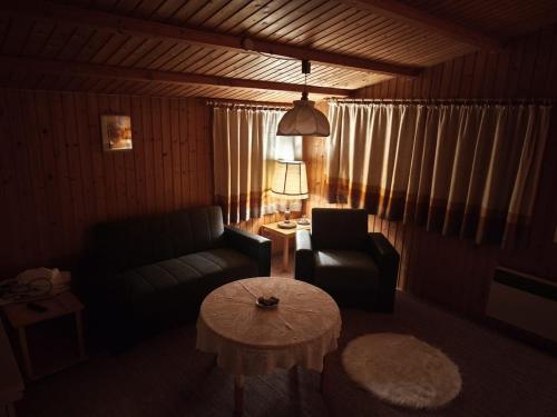 a living room with a couch and a table at Bergner's Blockhütte in Twielenfleth