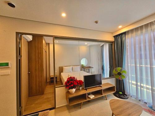 a bedroom with a bed and a television on a table at Cloud Nine The Song Vung Tau Homestay in Vung Tau