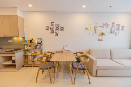 a living room with a table and a couch at Cloud Nine The Song Vung Tau Homestay in Vung Tau