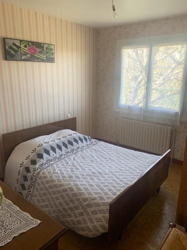 a bedroom with a bed in a room at Chez Frédérique in Romagne