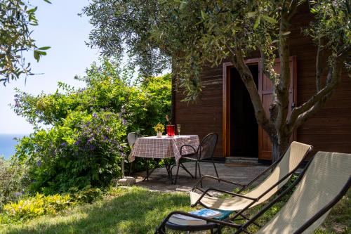 a table and chairs sitting outside of a house at Agriturismo Natta Di Monte Tabor in Celle Ligure