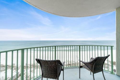 two chairs sitting on a balcony overlooking the ocean at Perdido Towers West 906 in Perdido Key