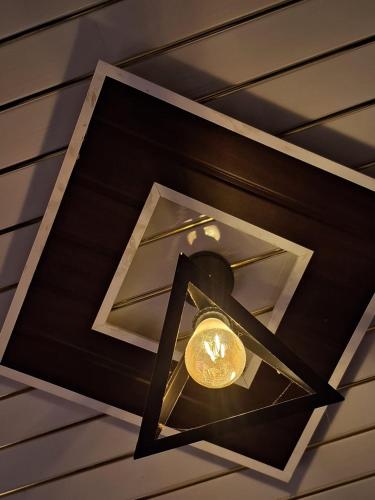 a light hanging from the ceiling of a room at Privyrooms GORAKHPUR in Gorakhpur