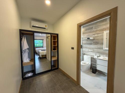 a bathroom with a toilet and a sink at BOX BOX Hotel and Sports Restaurant in Sattahip