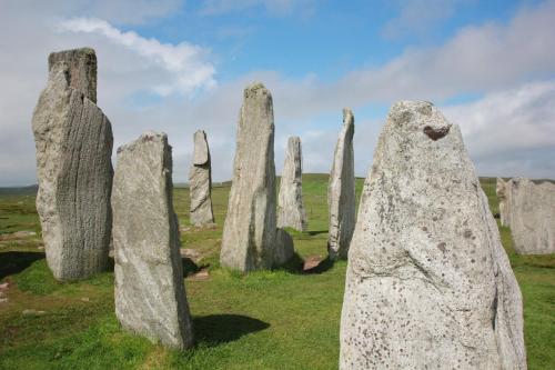 a group of large stone sculptures in a field at An Airigh in Stornoway