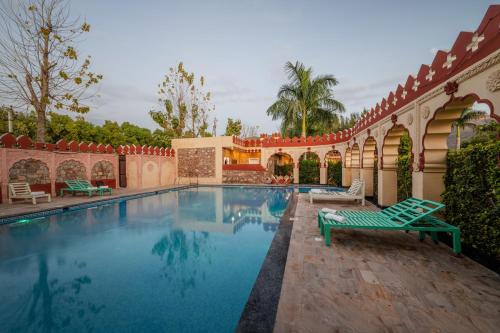 a swimming pool in a courtyard with a house at The Countryside Resorts - Refined by Nature in Pushkar