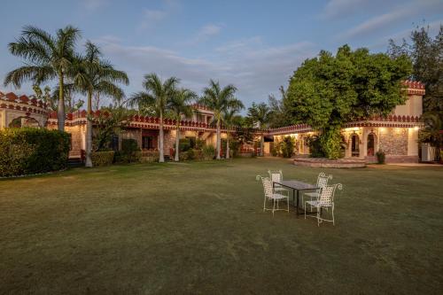 a table and chairs in the yard of a house at The Countryside Resorts - Refined by Nature in Pushkar