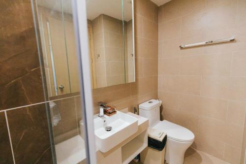 a bathroom with a toilet and a sink and a shower at Cloud Nine The Song Vung Tau Homestay in Vung Tau