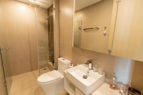 a bathroom with a toilet and a sink and a shower at Cloud Nine The Song Vung Tau Homestay in Vung Tau