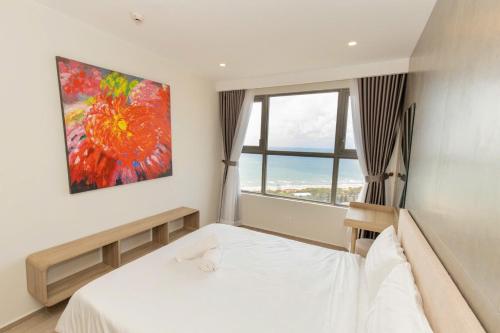 a bedroom with a bed and a painting on the wall at Cloud Nine The Song Vung Tau Homestay in Vung Tau