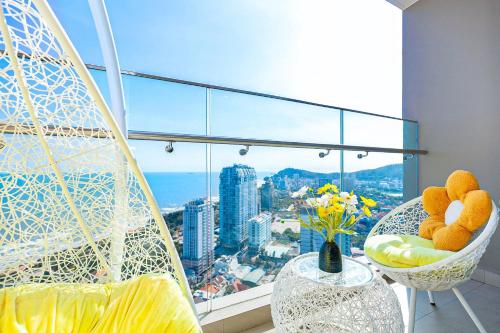 a room with a balcony with a view of a city at Cloud Nine The Song Vung Tau Homestay in Vung Tau