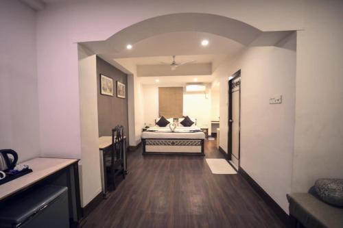 a bedroom with a bed in the middle of a room at Hotel Prag Continental in Guwahati