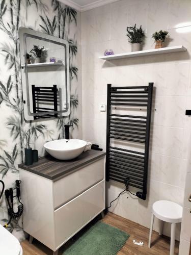 a bathroom with a sink and a mirror at Donnabellahome in Ajo