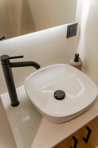 a white sink sitting on a counter in a bathroom at Casa Myrtēssa in Myrtos