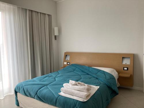 a bedroom with a bed with towels on it at Home & B in Arezzo