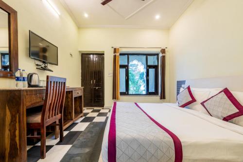 a bedroom with a bed and a desk and a sink at The Countryside Resorts - Refined by Nature in Pushkar