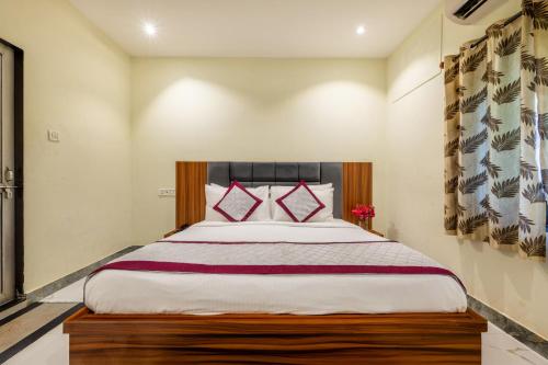 a bedroom with a large bed with red pillows at The Countryside Resorts - Refined by Nature in Pushkar