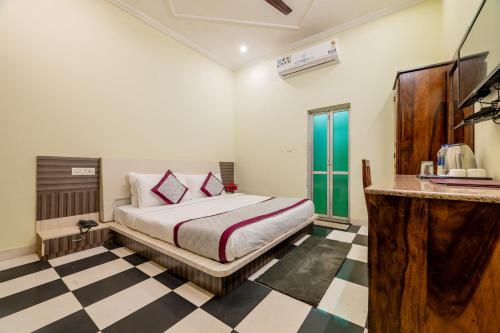 a bedroom with a bed and a checkered floor at The Countryside Resorts - Refined by Nature in Pushkar