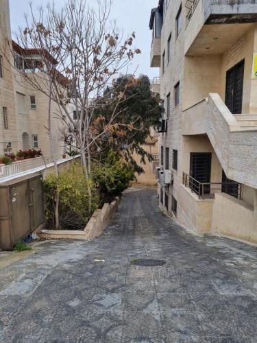 an empty street in an alley between buildings at unique one bedroom at abdoun 005 in Amman