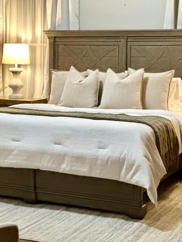 a bedroom with a large bed with white sheets and pillows at The Underwood-Hale House in Providence