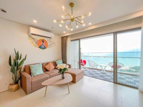 a living room with a couch and a table at Cloud Nine The Song Vung Tau Homestay in Vung Tau