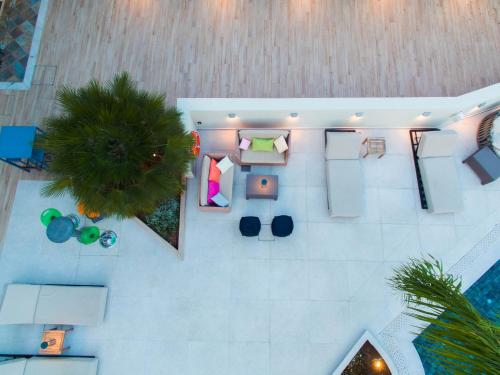 an overhead view of a room with a bed and chairs at Flisvos Royal Hotel & Suites in Tolo