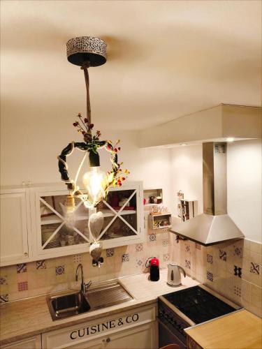 a kitchen with a chandelier hanging from the ceiling at Maison du VALe in Sesta Godano