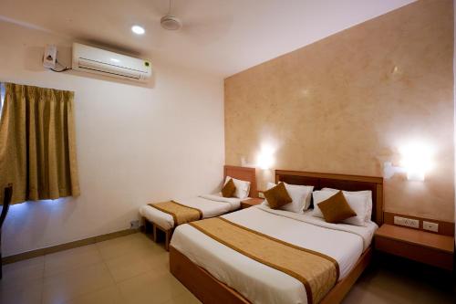 Postel nebo postele na pokoji v ubytování Avenue 11 Boutique Residences, Poes Garden Chennai